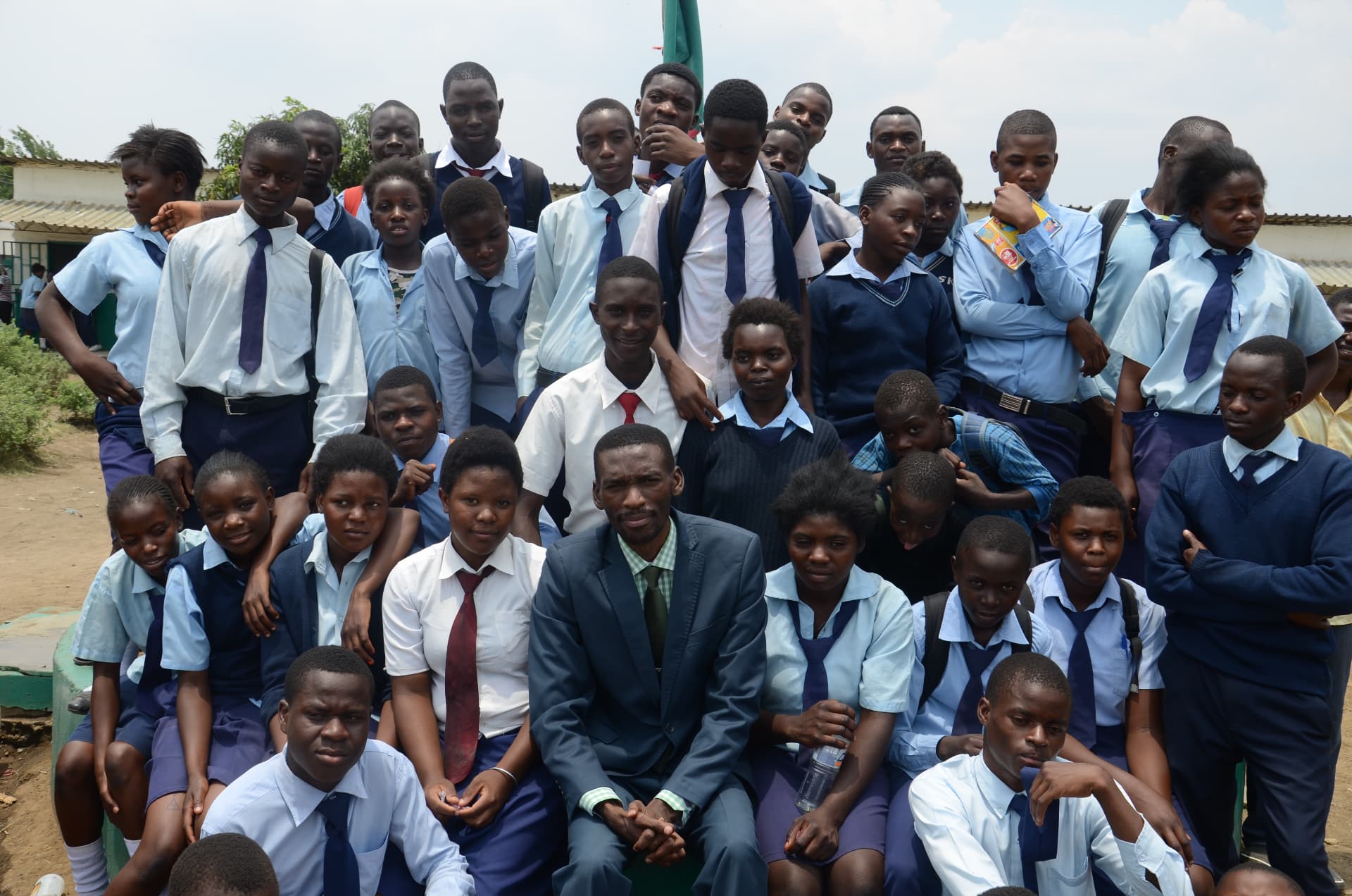 Secondary school students in uniform gathered with MCF