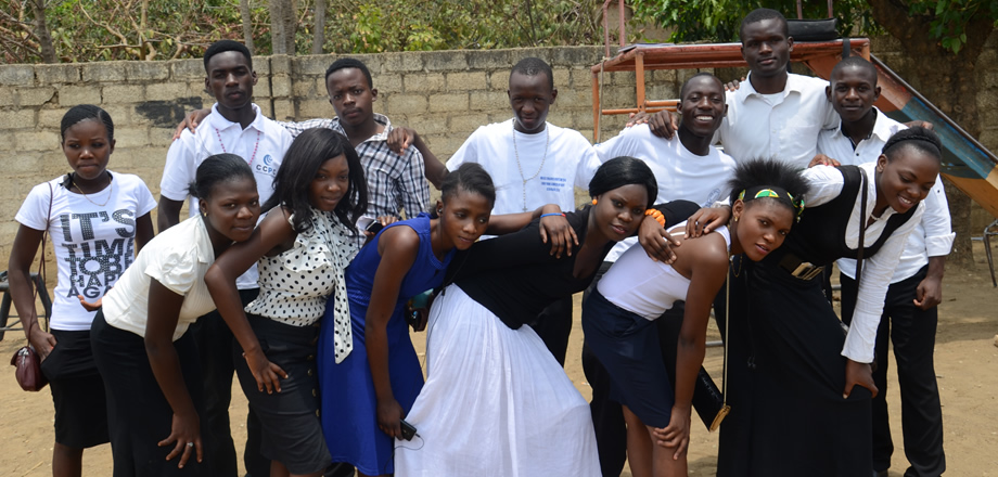 A group of young men and women in smart dress outdoors